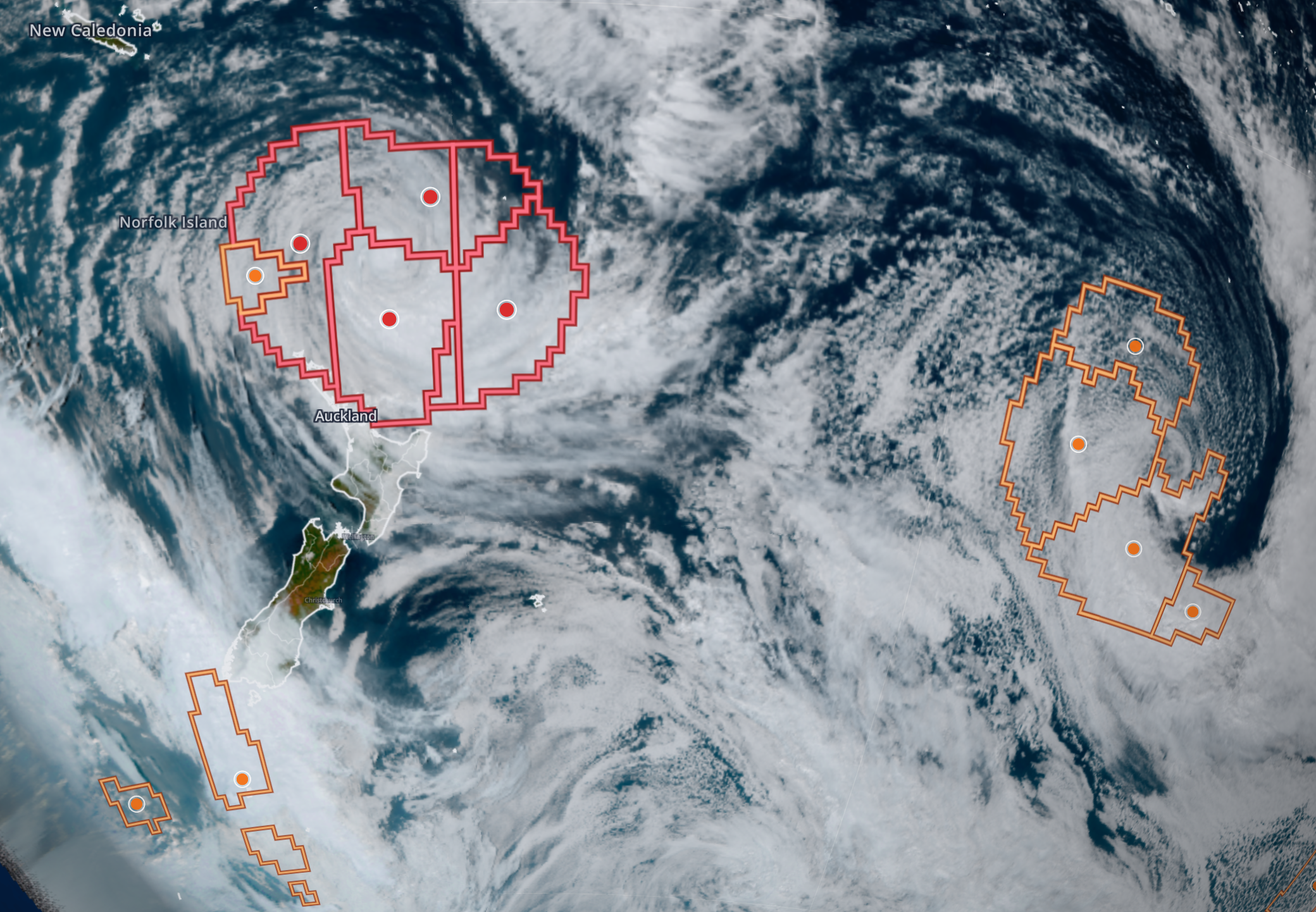 Satellite view with outlined hazard polygons and tracked event centroids around Tropical Cyclone Vaianu as it crosses the northern tip of New Zealand on April 10, 2026.